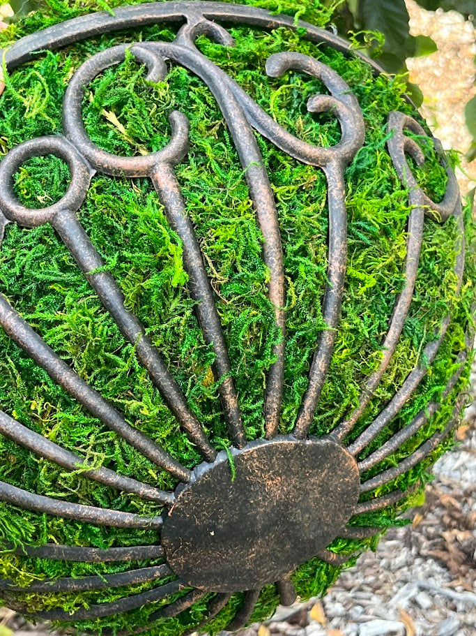 Decorative metal basket on a bed of green moss