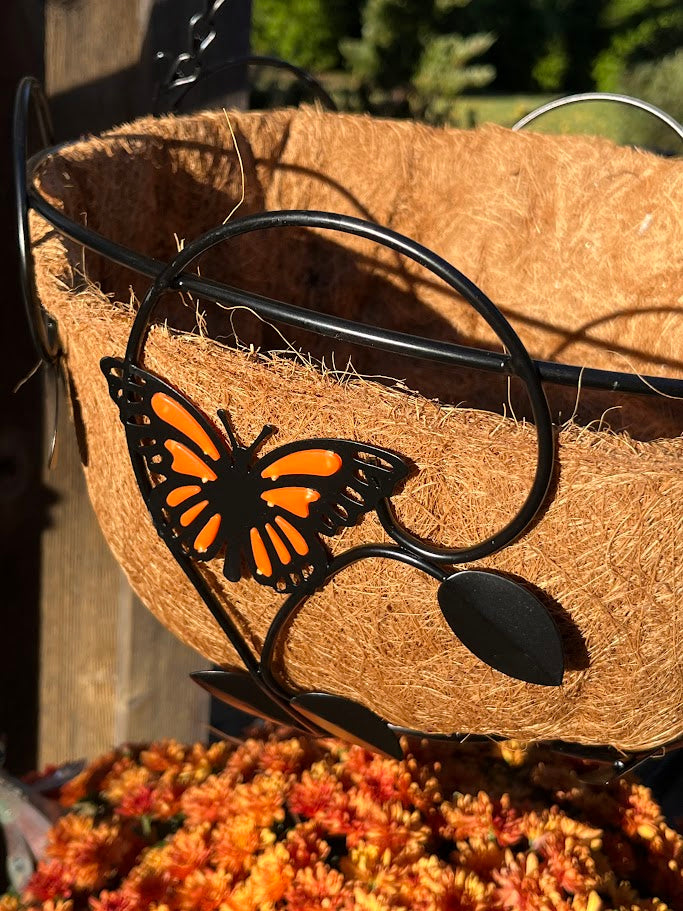 Sunglasses with a butterfly design on a doormat outdoors