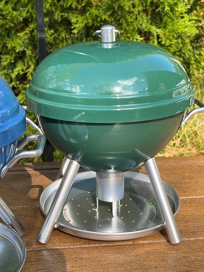 Green BBQ shaped Birdfeeder against a greenery background