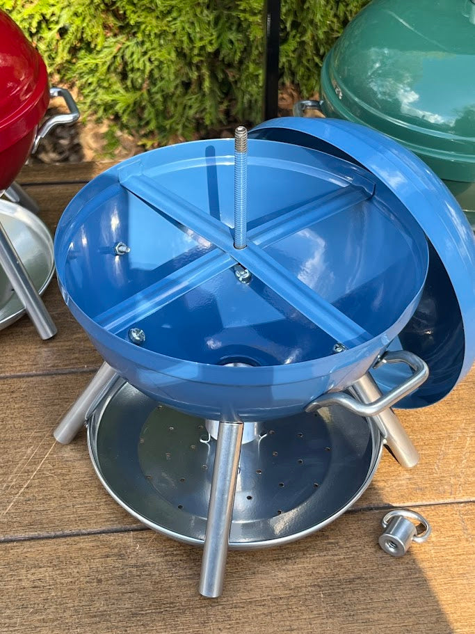 Inside parts of a Blue BBQ shaped Birdfeeder against a greenery background