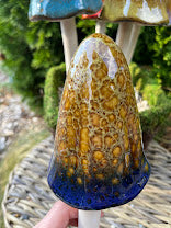 Fairy garden mushroom with a textured surface on a stick