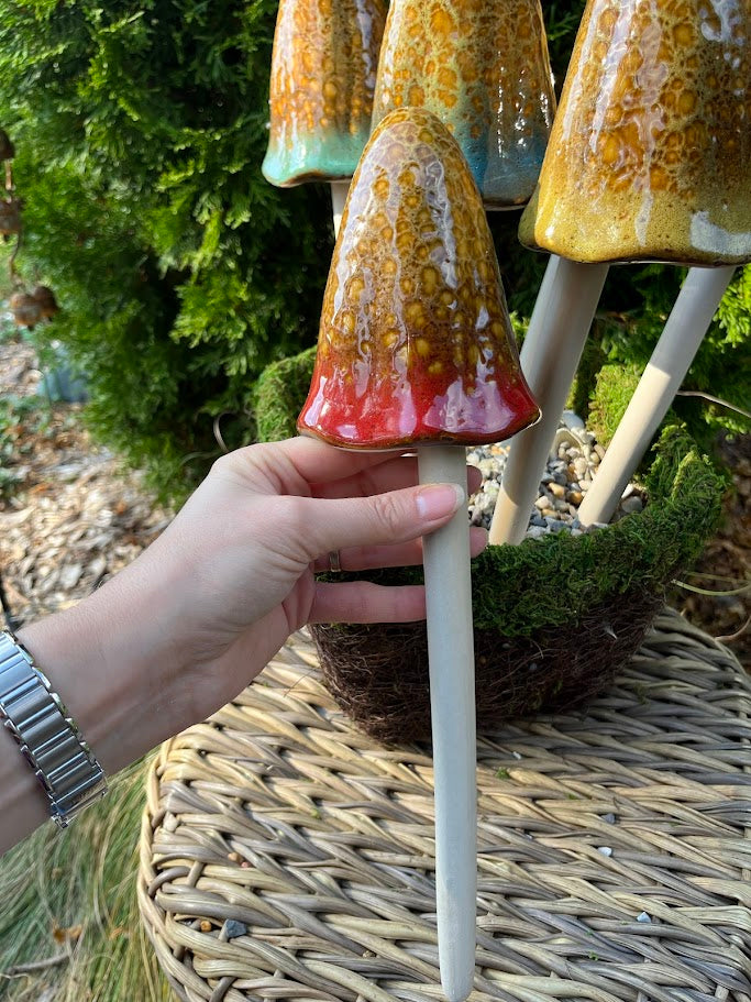 Decorative item with a hand holding it, set against a natural background