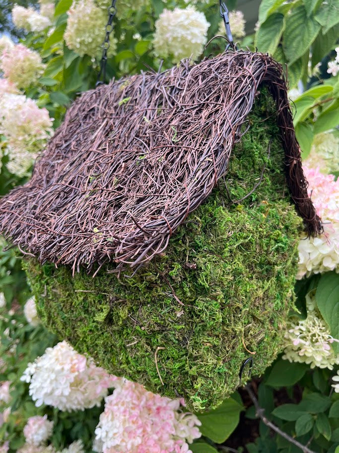 Mossy birdhouse with floral background