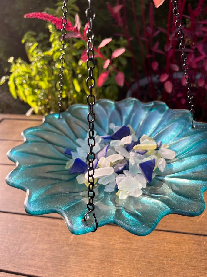 Decorative glass dish with flowers on a wooden surface