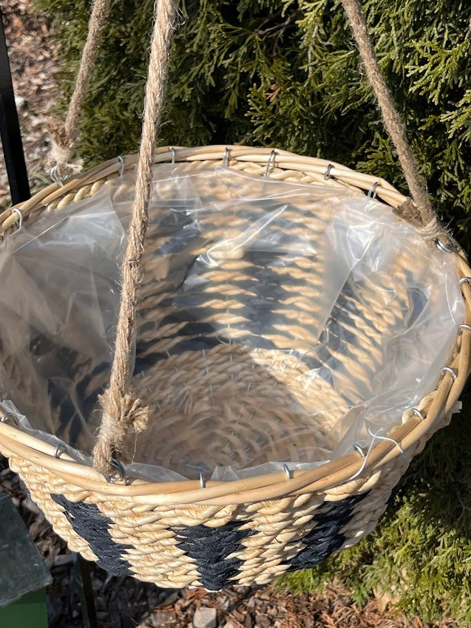 Woven hanging basket with clear plastic liner against a natural background
