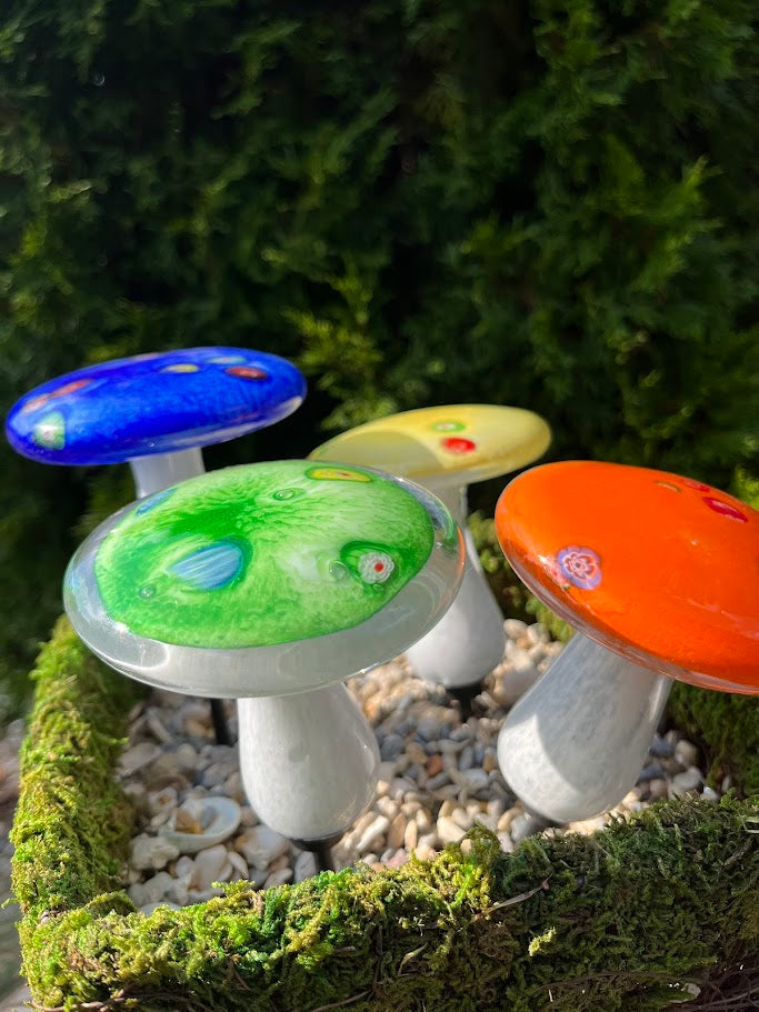 Colorful mushroom-shaped lights on a green background