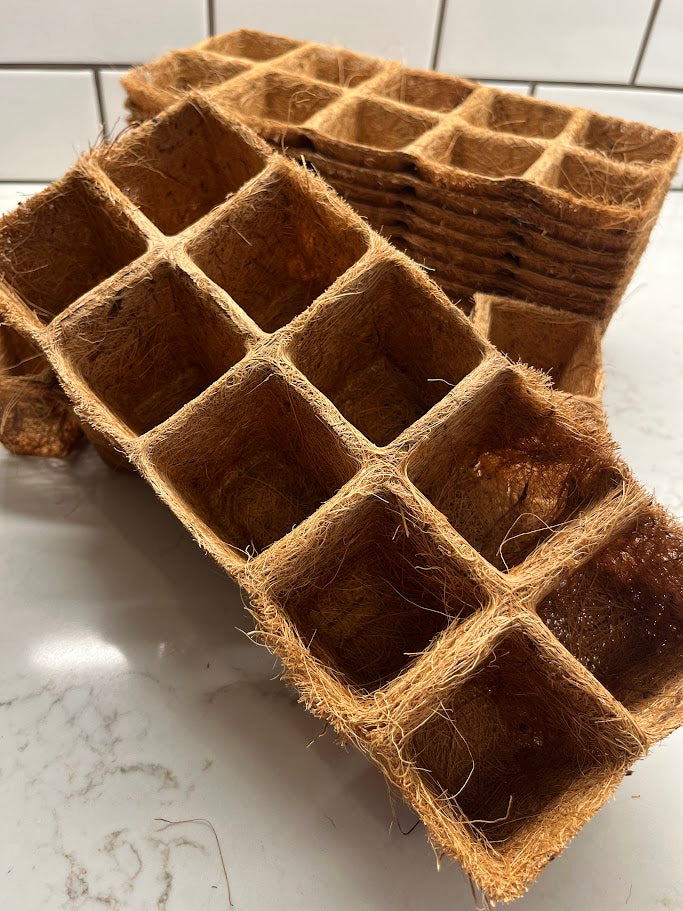 Brown seedling trays on a white marble surface