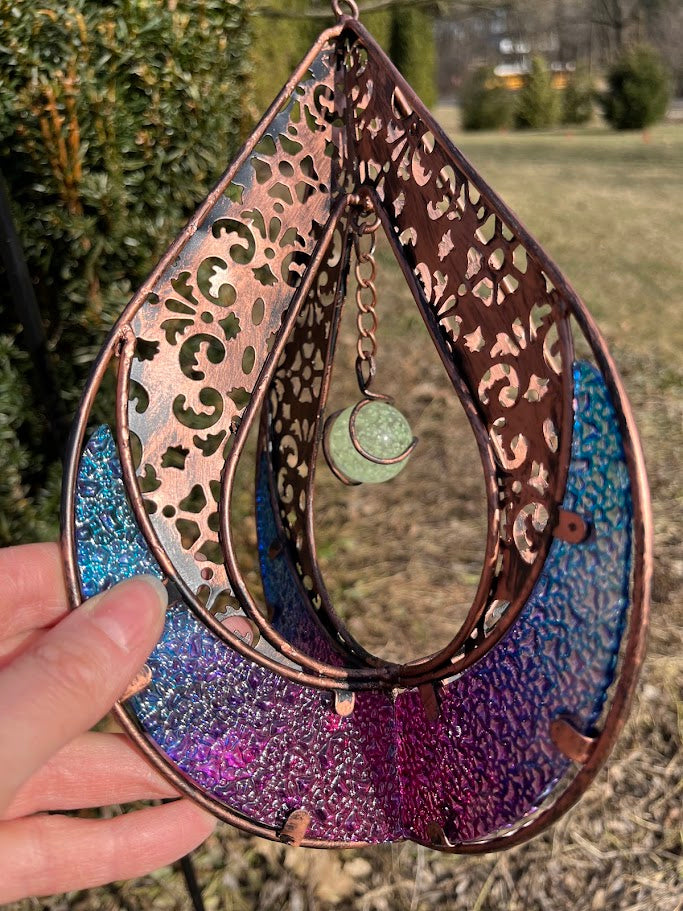 Decorative hanging item with intricate patterns and colors on a natural background