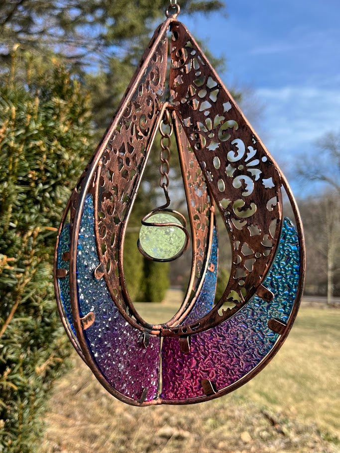 Decorative hanging item with intricate patterns and colors on a natural background