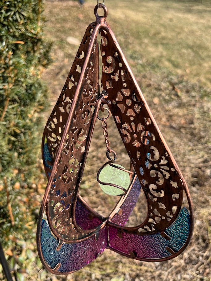 Decorative hanging item with intricate patterns and colors on a natural background
