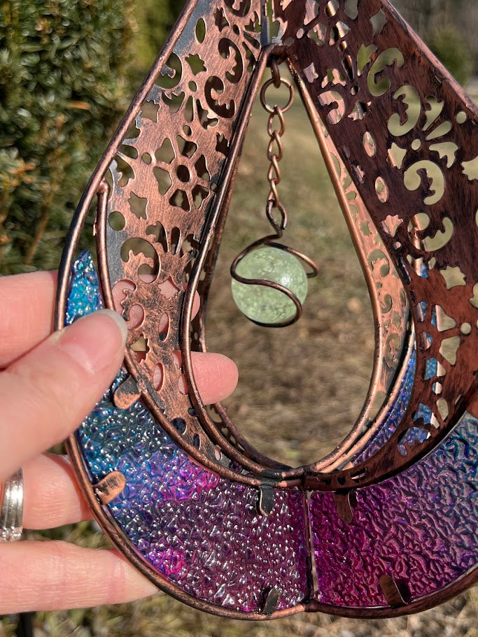 Decorative hanging item with intricate patterns and colors on a natural background