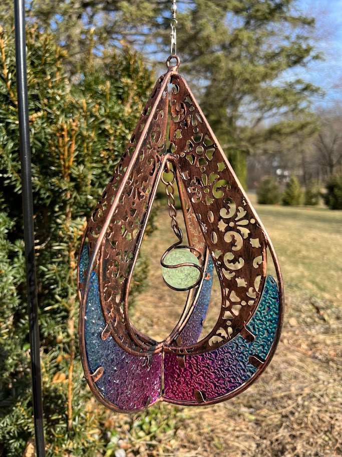 Decorative hanging item with intricate patterns and colors on a natural background